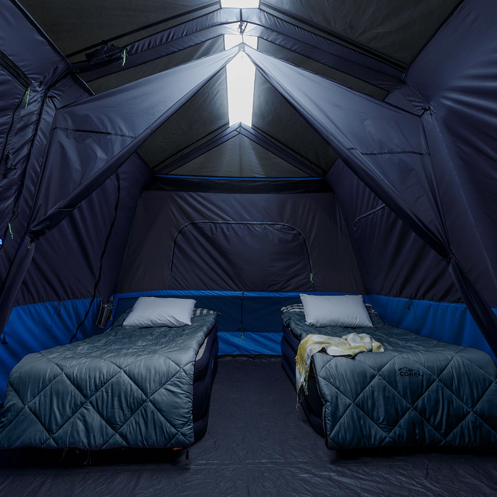 A large, orange and gray CORE 10-person instant tent with a lighted screen room. The tent has a spacious interior and multiple windows, providing ample ventilation and natural light.