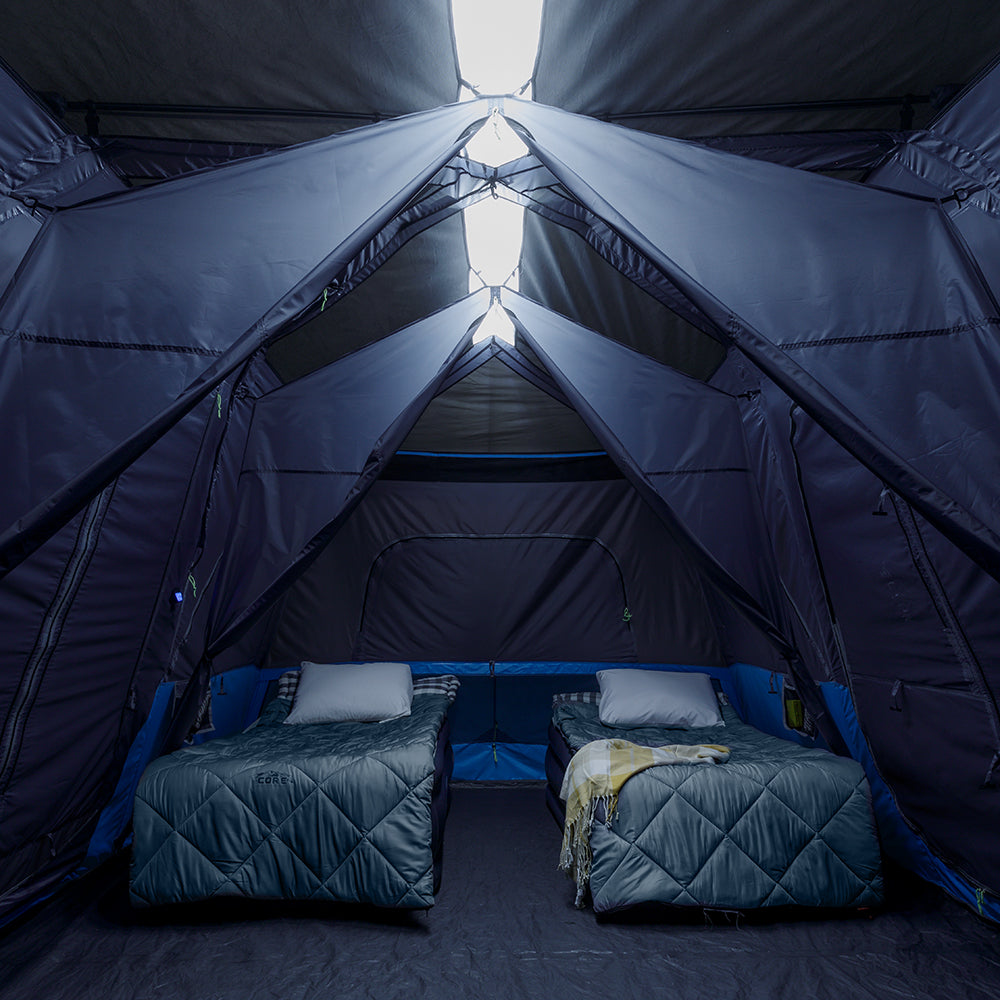 A large, brown CORE 12-person instant cabin tent measuring 18 feet by 10 feet. The tent features built-in LED lights for added convenience and safety, and it has a spacious interior, multiple windows, and a sturdy frame for easy setup.