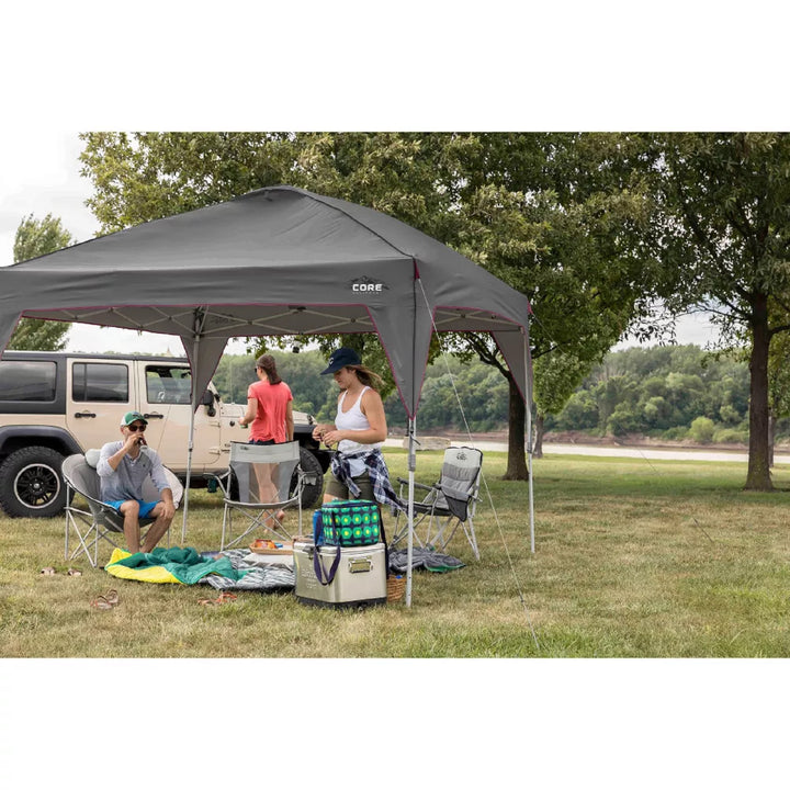  A large, orange and gray CORE 10' x 10' instant canopy, also known as a gazebo. The canopy has a pop-up design for quick and easy setup, and it provides shade and shelter for outdoor activities.