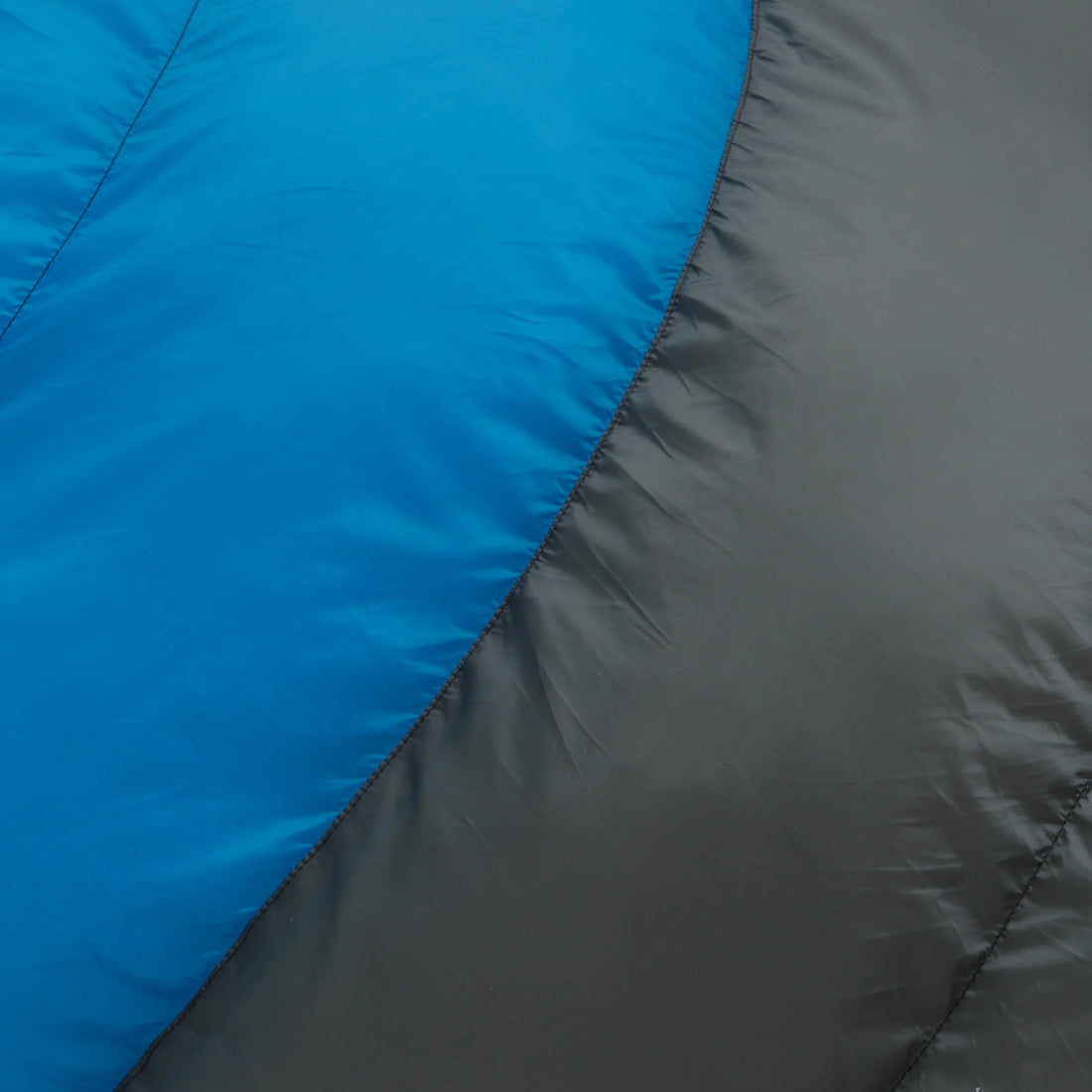 A blue and gray CORE 10-degree mummy sleeping bag. The sleeping bag is designed for cold weather camping and features a mummy shape for warmth and insulation.