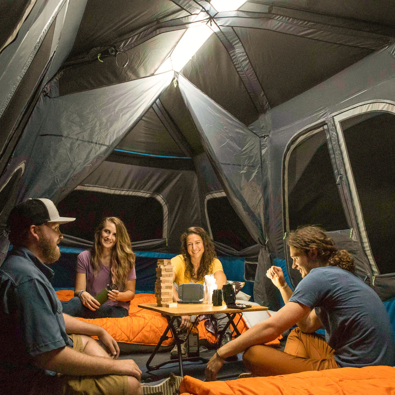 A large, brown CORE 12-person instant cabin tent measuring 18 feet by 10 feet. The tent features built-in LED lights for added convenience and safety, and it has a spacious interior, multiple windows, and a sturdy frame for easy setup.
