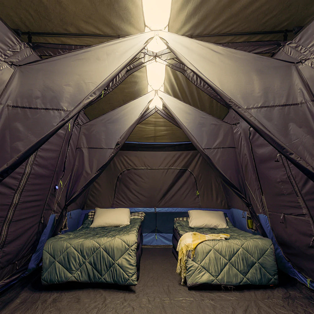 A large, brown CORE 12-person instant cabin tent measuring 18 feet by 10 feet. The tent features built-in LED lights for added convenience and safety, and it has a spacious interior, multiple windows, and a sturdy frame for easy setup.