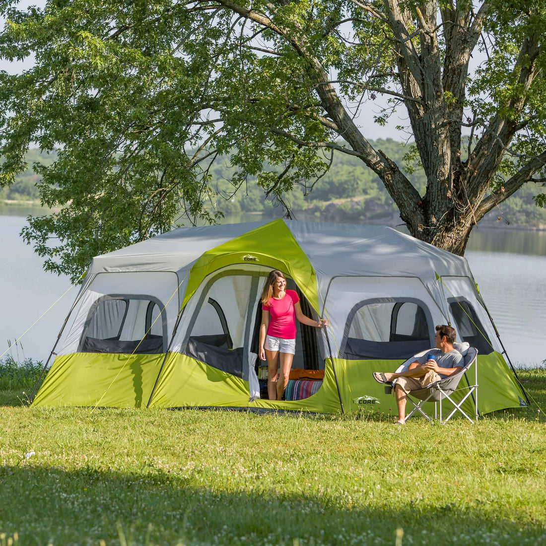 A large, brown CORE 12-person instant cabin tent measuring 18 feet by 10 feet. The tent has a spacious interior, multiple windows, and a sturdy frame for easy setup