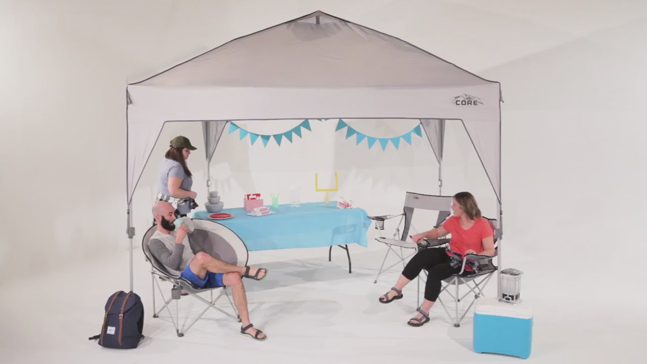 A large, orange and gray CORE 10' x 10' instant canopy, also known as a gazebo. The canopy has a pop-up design for quick and easy setup, and it provides shade and shelter for outdoor activities.