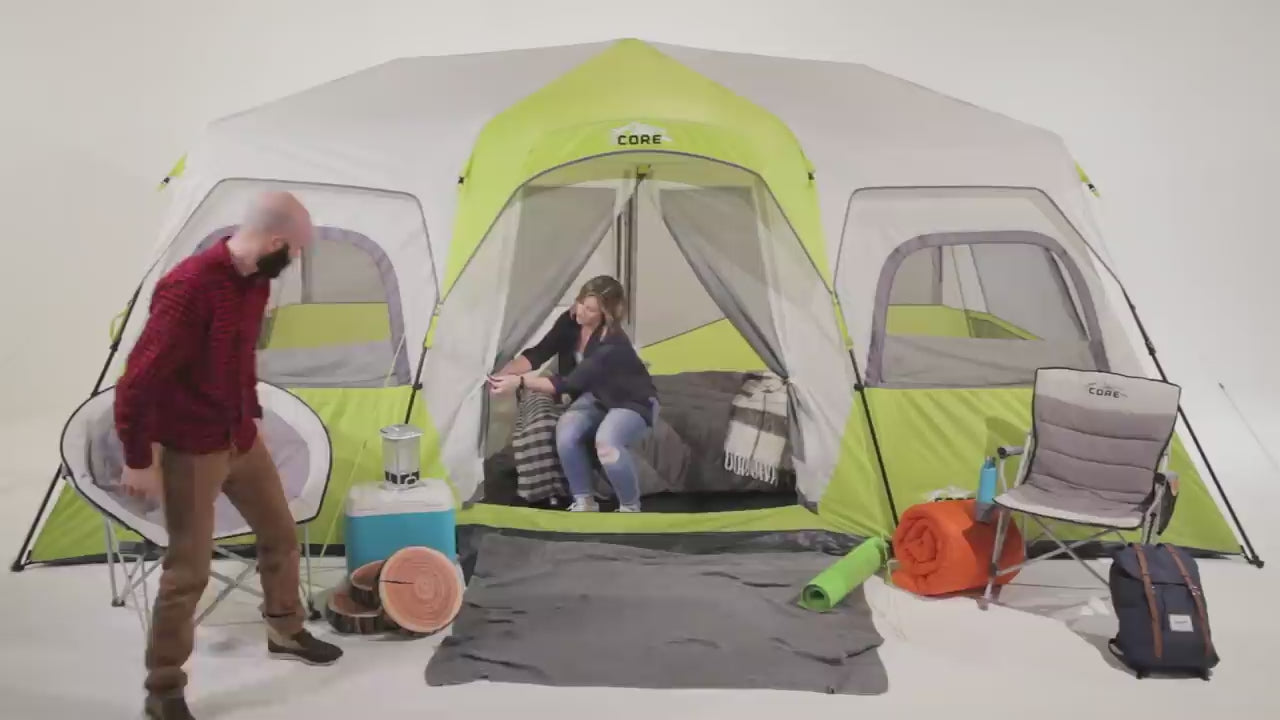 A large, brown CORE 12-person instant cabin tent measuring 18 feet by 10 feet. The tent has a spacious interior, multiple windows, and a sturdy frame for easy setup